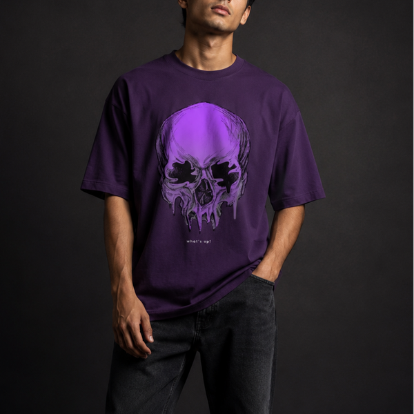 Person wearing a purple t-shirt with a skull design on a dark background